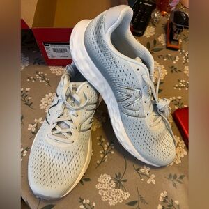 New Balance Light Blue Sneakers. New condition in Box. Size 9.5 Medium.
